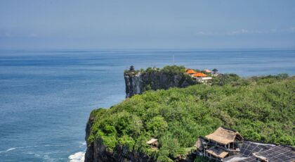 Majestic cliffside views overlooking the sea in Bali, highlighting lush greenery and architecture.